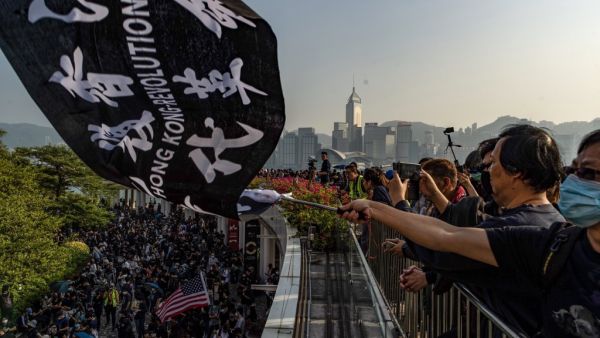 People take part in a march from Tsim Sha Tsui to Hung Hom in Hong Kong on December 1, 2019. Police fired tear gas and pepper spray in Hong Kong on December 1 as tens of thousands of black-clad protesters flooded into the streets, a week after pro-democracy candidates scored a landslide local election victory. (Philip FONG / AFP)
