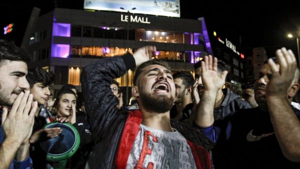 Protesters chant slogans and strike a tabla during an anti-government demonstration in the southern Lebanese city of Sidon on December 1, 2019. Mahmoud ZAYYAT / AFP