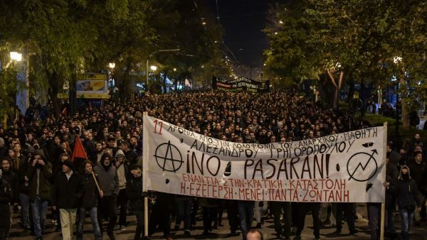 People carry a giant banner reading "They shall not pass" as they march in central Athens on December 6, 2019 after a rally commemorating the death of a 15-year-old teenager, who was fatally shot by a police officer in 2008. (AFP/ File Photo)