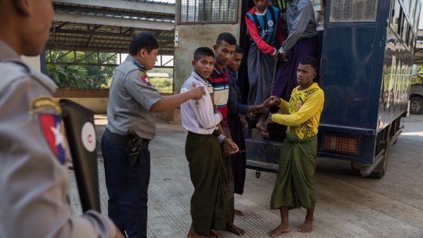 Rohingya detainees step out of a police van upon arriving at the court in the western Myanmar city of Pathein ahead of a hearing on December 11, 2019. (AFP/ File Photo)