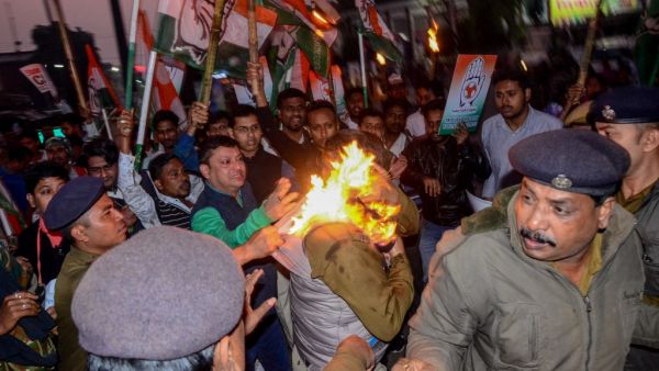 Police personnel try to rescue a police officer (C) caught on fire during a protest against the government's Citizenship Amendment Bill (CAB) in Agartala, the capital of India's northeastern state of Tripura on December 11, 2019. (AFP/ File Photo)