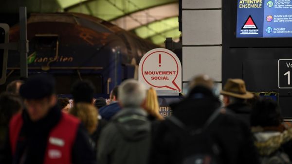 Commuters stand on a SNCF regional train platform at Gare du Nord in Paris on December 11, 2019 during a strike of public transports operator SNCF and RATP employees over French government's plan to overhaul the country's retirement system, as part of a national strike. Alain JOCARD / AFP