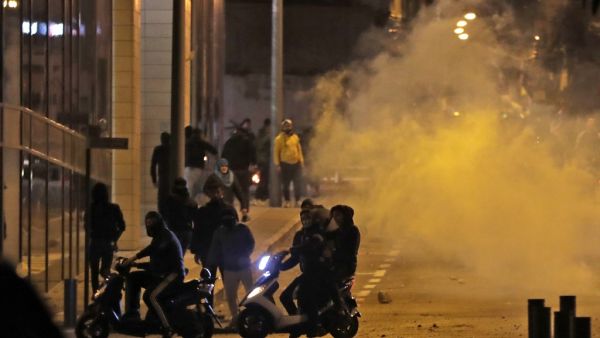 Supporters of Lebanon's Shiite Hezbollah and Amal groups clash with riot police as they were heading to the area where anti-government protests were taking place early on December 12, 2019 in central Beirut. ANWAR AMRO / AFP