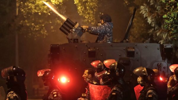 Lebanese riot police clash with supporters of Lebanon's Shiite Hezbollah and Amal groups as they were heading to the area where anti-government protests were taking place early on December 12, 2019 in central Beirut. ANWAR AMRO / AFP