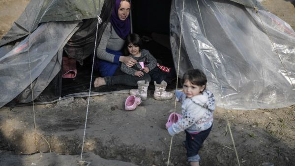 A syrian woman sits in her tent with her children in the Vial refugee camp, on the Greek island of Chios, on December 10, 2019.  (AFP/ File Photo)