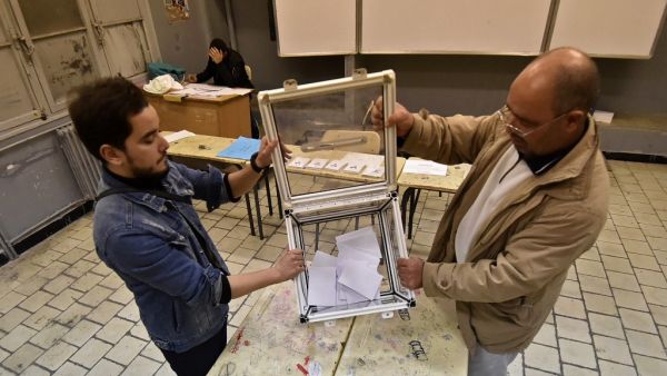 Election officials count ballot papers of the presidential election in the capital Algiers on December 12, 2019. Algeria held a tense presidential election meant to bring stability after a year of turmoil, but voting was marred as protesters stormed polling stations and staged mass rallies in the capital. RYAD KRAMDI / AFP