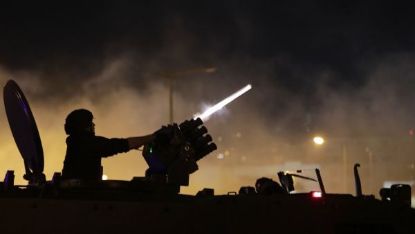 Lebanese riot police fire teargas canisters during clashes with anti-government demonstrators in the capital Beirut on December 14, 2019. ANWAR AMRO / SERVICES AFP / AFP