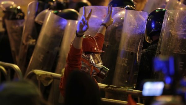 A Lebanese protester wearing protective gear flashes the victory sign at security forces, amid clashes which erupted during an anti-government demonstration in the downtown area of the capital Beirut on December 15, 2019.  (AFP/ File Photo)
