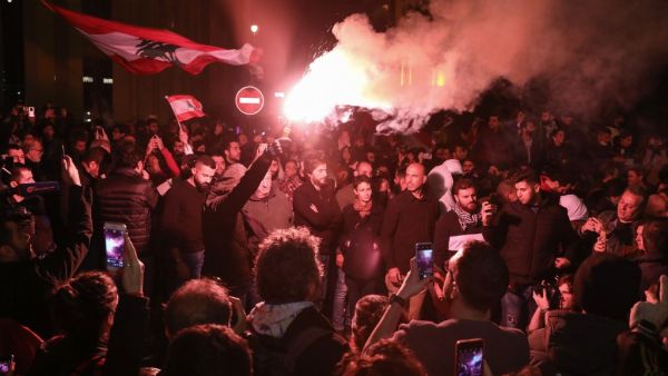 A Lebanese demonstrator uses a flare during an anti-government protest in the downtown area of the capital Beirut, on December 15, 2019.  (AFP/ File Photo)