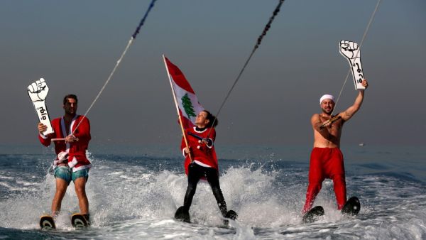 Members of a Lebanese water sports club dressed an Santa Claus (AFP)