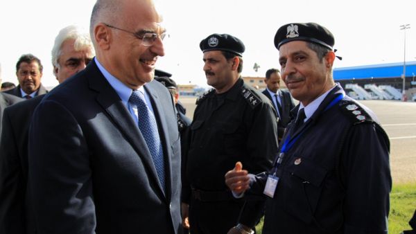 Libyan officials welcome Greek foreign Minister Nikos Dendias (L) upon his arrival to Benghazi airport on the eastern Libyan coast, on December 22, 2019. Greece's foreign minister visited Libya's Benghazi today, meeting representatives of strongman Khalifa Haftar's administration amid tensions with Turkey following Ankara's recent maritime agreement with Tripoli's unity government. Abdullah DOMA / AFP