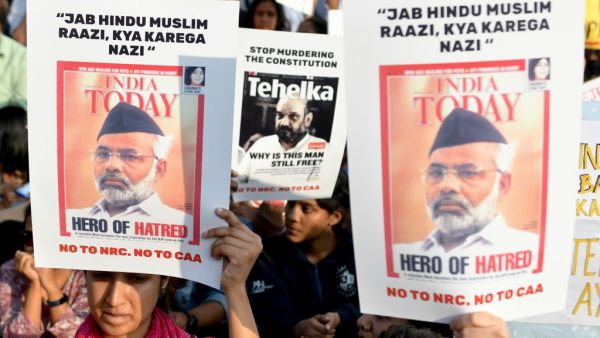 Protesters hold placards during a demonstration held against India's new citizenship law at the Town Hall in Bangalore on December 22, 2019. Prime Minister Narendra Modi sought on December 22 to reassure India's Muslims as a wave of deadly protests against a new citizenship law put his Hindu nationalist government under pressure like never before. Manjunath Kiran / AFP