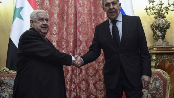 Russian Foreign Minister Sergey Lavrov (R) shakes hands with his Syrian counterpart Walid Muallem during their meeting in Moscow on December 23, 2019. Alexander NEMENOV / AFP