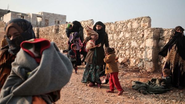 Displaced Syrians from the south of Idlib province queue to receive food aid from a truck in the countryside west of the town of Dana in the northwestern Syrian region on December 23, 2019. Aaref WATAD / AFP
