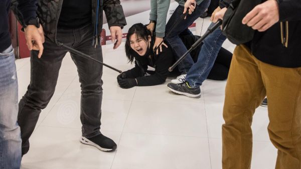 Plainclothes police officers detain a pro-democracy protester during a rally inside a shopping mall in Sheung Shui in Hong Kong on December 28, 2019. Hong Kong has been battered by more than six months of protests that has upended the financial hub's reputation for stability and helped tip the city into recession. DALE DE LA REY / AFP