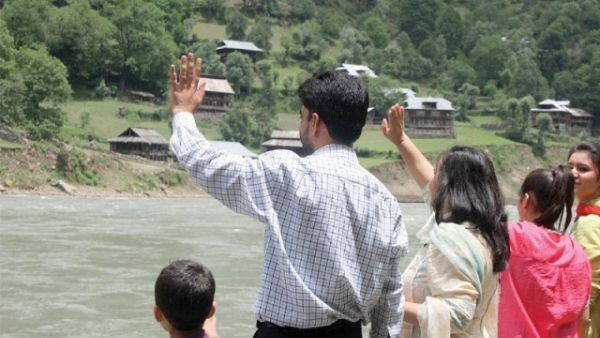Families wave to their relatives on the Indian side of the Neelum River. (AFP/ File Photo)
