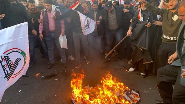 Protesters set fire to the outside walls of the US Embassy in Baghdad (Twitter)