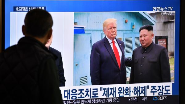 A man watches a television news programme showing file footage of a meeting between US President Donald Trump and North Korean leader Kim Jong Un at the truce village of Panmunjom, at a railway station in Seoul on January 1, 2020. North Korean leader Kim Jong Un has declared an end to its moratoriums on nuclear and intercontinental ballistic missile tests and threatened a demonstration of a "new strategic weapon" soon. Jung Yeon-je / AFP