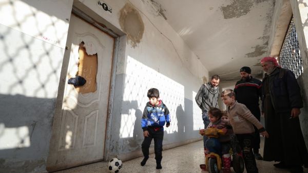 Children of Syrian families displaced from the Maaret Al-Numan region gather in the yard of a former jail turned into a makeshift refugee shelter in the northwestern city of Idlib on December 31, 2019, ahead of activities organised by a local aid association. (AFP/ File Photo)
