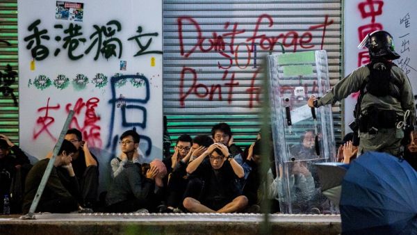 Police detain a group of people after a pro-democracy march in Hong Kong on January 1, 2020. Tens of thousands of protesters marched in Hong Kong during a massive pro-democracy rally on New Year's Day, looking to carry the momentum of their movement into 2020.  ISAAC LAWRENCE / AFP