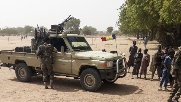 Soldiers of the Chad Army stand next to a Land Cruiser, while bystanders look on, before buing sheep at the Koundoul market, 25 km from N'Djamena, on January 3, 2020, upon their return after a months-long mission fighting Boko Haram in neighbouring Nigeria. (AFP/ File Photo)
