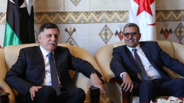 Algeria's Prime Minister Abdelaziz Djerad (R) meets with Libya's UN-recognised Prime Minister Fayez al-Sarraj upon his arrival in Algiers on January 6, 2020 for talks on the Libyan crisis. (AFP/ File Photo)