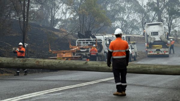 Firefighters were racing to contain massive bushfires across southeastern Australia Tuesday amid easing conditions as another heatwave loomed, as officials said the damage bill for the months-long crisis had risen to almost half a billion dollars.  SAEED KHAN / AFP