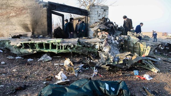 People stand near the wreckage after a Ukrainian plane carrying 176 passengers crashed near Imam Khomeini airport in Tehran on January 8, 2020. All 176 people on board a Ukrainian passenger plane were killed when it crashed shortly after taking off from Tehran on January 8, Iranian state media reported. State news agency IRNA said 167 passengers and nine crew members were on board the aircraft operated by Ukraine International Airlines. Rouhollah VAHDATI / ISNA / AFP
