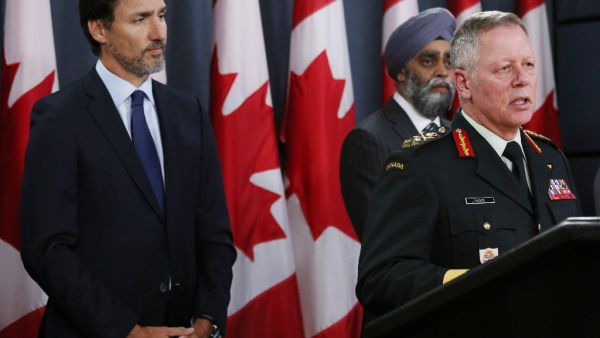 Canadian Prime Minister Justin Trudeau (L), Minister of National Denfence Harjit Sajjan (C) listen as Chief of Defence Staff General Jonathan Vance addresses the media during a news conference January 8, 2020 in Ottawa, Canada. Dave Chan / AFP