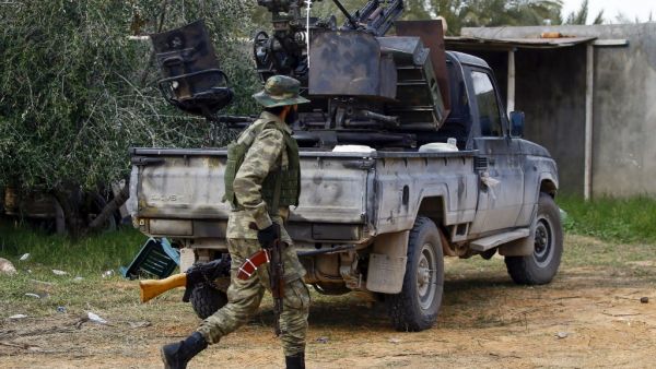 A fighter loyal to the internationally recognised Libyan Government of National Accord (GNA) walks past a vehicle in an area south of the Libyan capital Tripoli on January 12, 2020. (AFP/ File Photo)
