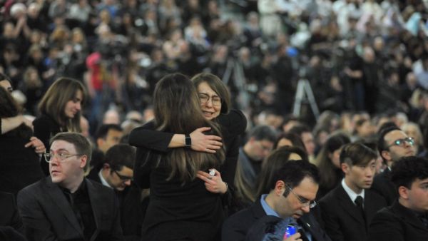 Mourners console each other as they gather at a memorial service for the victims of Ukrainian Airlines flight PS752 crash in Iran at the Saville Community Sports Centre in Edmonton, Canada on January 12, 2020. Walter Tychnowicz / AFP
