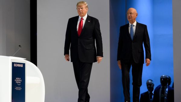 In this file photo taken on January 26, 2018, US President Donald Trump (L) arrives on stage followed by Founder and Executive Chairman of the World Economic Forum (WEF) Klaus Schwab before delivering his speech at the World Economic Forum (WEF) annual meeting in Davos, eastern Switzerland. (AFP)