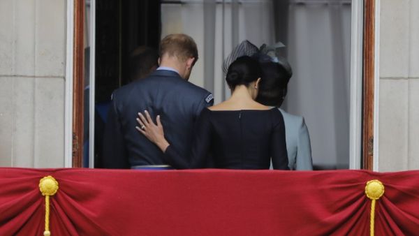 In this file photo taken on July 10, 2018 Britain's Meghan, Duchess of Sussex (R) puts her hand on Britain's Prince Harry, Duke of Sussex's back as they leave the balcony of Buckingham Palace in London. (AFP/ File Photo)