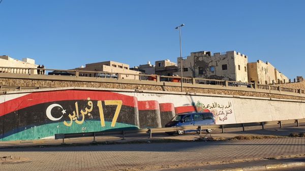 A vehicle passes by a mural inspired by the 2011 NATO-backed Libya uprising, in the Libyan capital Tripoli's old quarter, on January 20, 2020. A peaceful solution to Libya's protracted conflict remains uncertain despite an international agreement struck in Germany, analysts say, as a fragile ceasefire between warring factions brought only a temporary truce. Mahmud TURKIA / AFP