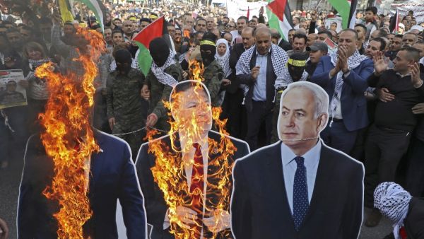 In this file photo taken on November 26, 2019, Palestinian protesters burn cardboard cutouts of US President Donald Trump, State Secretary Mike Pompeo, and Israeli Prime Minister Benjamin Netanyahu, during a demonstration in the center of Nablus in the occupied West Bank. (AFP/ File Photo)