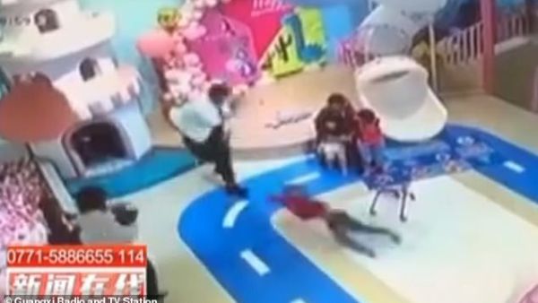 The man savagely flings the boy, causing the child to spin in the air before landing on the floor. (Video Screenshot)