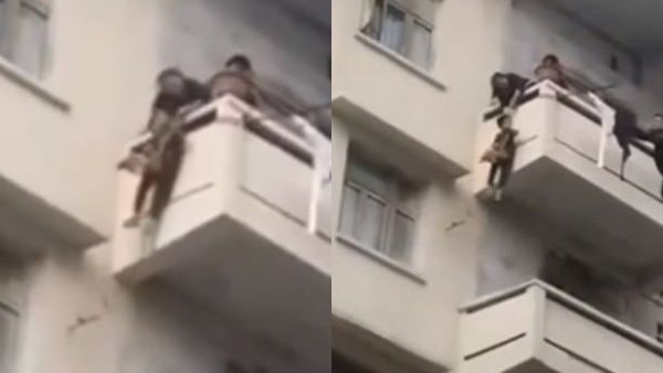 The pensioner hauls in the rope to pull up her grandson after he put the cat in a bag which he is carrying. The risky rescue operation reportedly took place on Sunday in Peng'an, China. (Video Screenshots)
