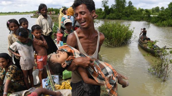A Rohingya refugee reacts while holding his dead son after crossing the Naf river from Myanmar into Bangladesh in Whaikhyang on Oct. 9, 2017. (Indranil Mukherjee/AFP/Getty Images)