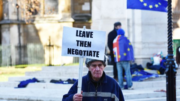 A pro Brexit protestor rooting for a hard Brexit ie the UK 'crashing out' of the European Union without a deal, holding a banner stating 'Leave Then Negotiate'. (Shutterstock/ File Photo)