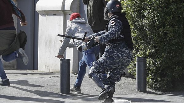 Anti-government protesters throw stones during clashes with security forces amidst a demonstration in the centre of the Lebanese capital Beirut on January 27, 2020. JOSEPH EID / AFP