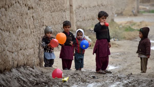 Children play with balloons along a street in Kandahar Province on January 28, 2020. JAVED TANVEER / AFP