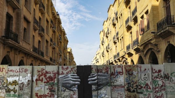 This picture taken on January 28, 2020 shows a view of a graffiti-covered concrete barrier erected by Lebanese security forces separating Riad al-Solh square from the parliament headquarters in the capital Beirut's central downtown district. JOSEPH EID / AFP