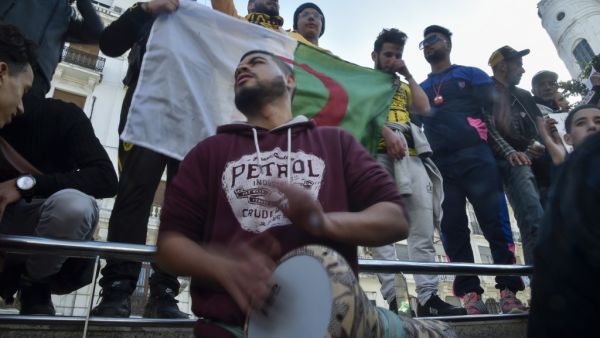 An Algerian protester beats the darbuka while others chant during an anti-government demonstration in the capital Algiers, on January 31, 2020. RYAD KRAMDI / AFP