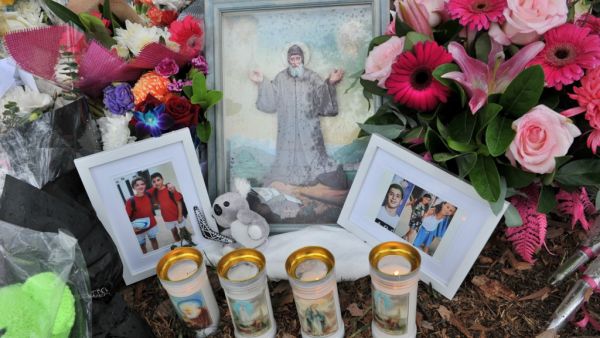 Flowers and images of those involved in the accident are pictured at a makeshift memorial at the site of an accident which killed four children the day before, in the Oatlands suburbs of Sydney on February 2, 2020. Farooq KHAN / AFP