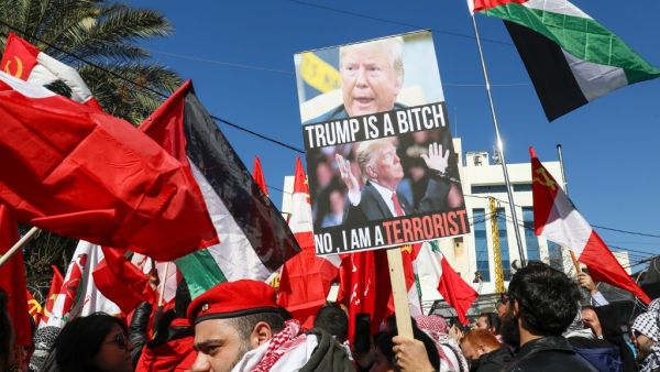 Demonstrators wave the Palestinian flag and leftist flags during a demonstration against the US peace plan proposal, near the US embassy in Awkar, northeast of the capital Beirut on February 2, 2020. ANWAR AMRO / AFP