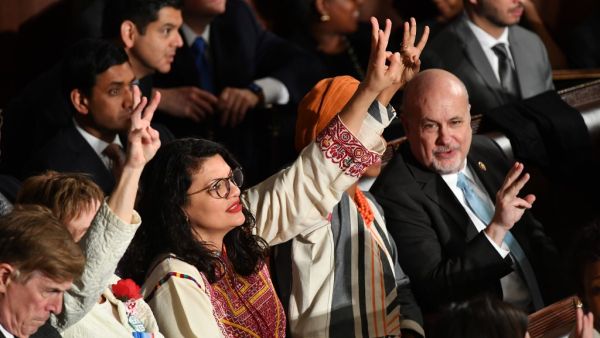 Representative for Minnesota Ilhan Omar (R) and Representative for Michigan Rashida Tlaib (L) gesture as US President Donald Trump delivers the State of the Union address at the US Capitol in Washington, DC, on February 4, 2020.  MANDEL NGAN / AFP