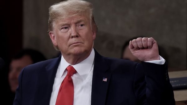 President Donald Trump pumps his fist as he delivers the State of the Union address in the chamber of the US House of Representatives at the US Capitol Building on February 4, 2020 in Washington, DC. Olivier DOULIERY / AFP