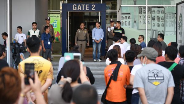 People gather outside the Terminal 21 shopping mall as they seek information on picking up vehicles and other belongings left during a mass shooting at the complex in Nakhon Ratchasima on February 9, 2020.  AFP