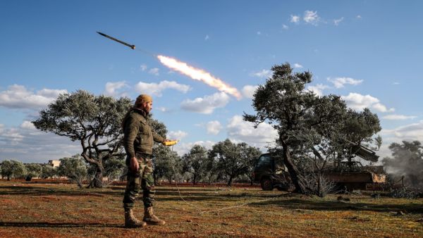 A Syrian rebel fighter remotely-fires a rocket from a truck-mounted launcher at a position in the countryside of Idlib towards regime forces positions in the southern countryside of Syria's Aleppo province on February 10, 2020. Omar HAJ KADOUR / AFP