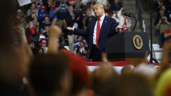 US President Donald Trump looks at his supporters after reading words from Al Wilson's song "The Snake" during a rally in Manchester, New Hampshire on February 10, 2020. JIM WATSON / AFP